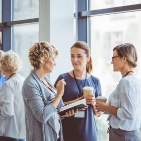Group of women talking during coffee break at convention center. Break during a women seminar.